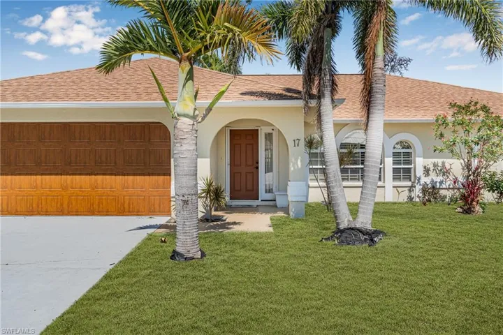 View of front facade with an attached garage, roof with shingles, driveway, stucco siding, and a front lawn