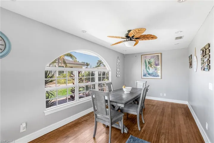 Dining room featuring wood-type flooring, baseboards, and ceiling fan