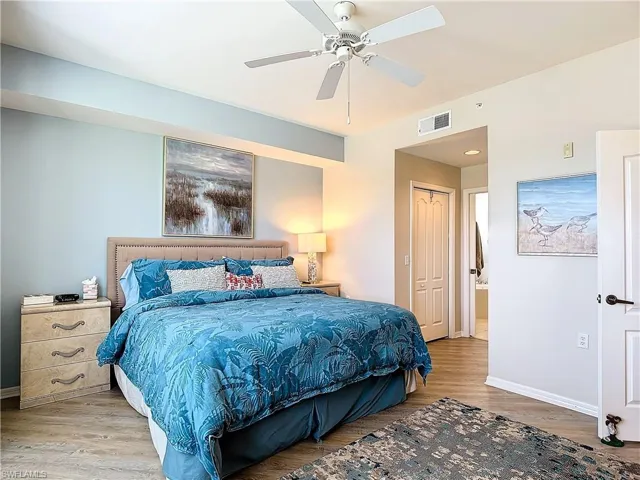 Bedroom featuring light hardwood / wood-style flooring, a closet, and ceiling fan