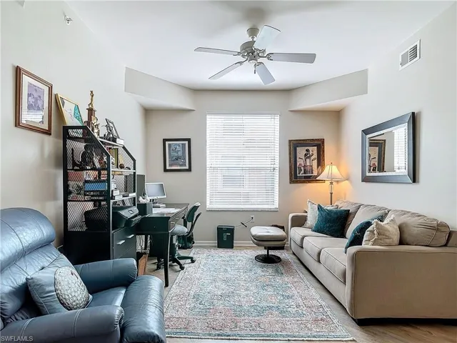 Living room with hardwood / wood-style flooring and ceiling fan