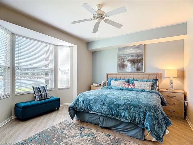 Bedroom with light hardwood / wood-style flooring and ceiling fan