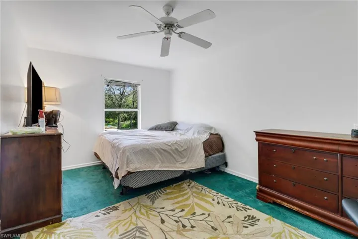 Carpeted bedroom with ceiling fan
