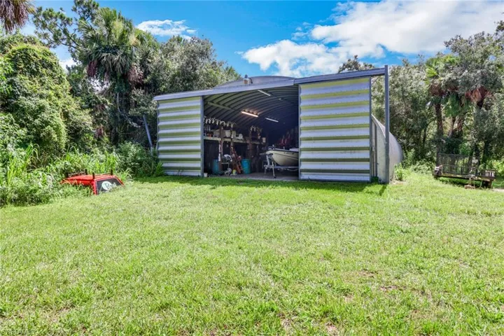 View of outdoor structure with a lawn