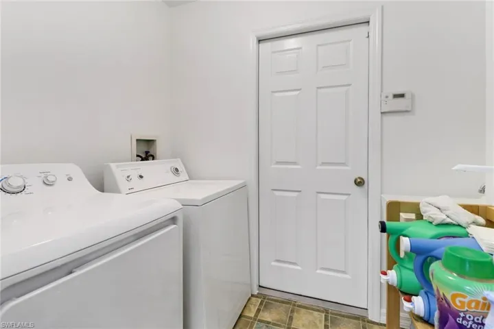 Laundry area featuring washing machine and clothes dryer