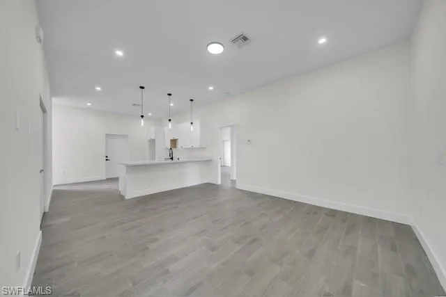 Unfurnished living room with recessed lighting and light wood-style flooring