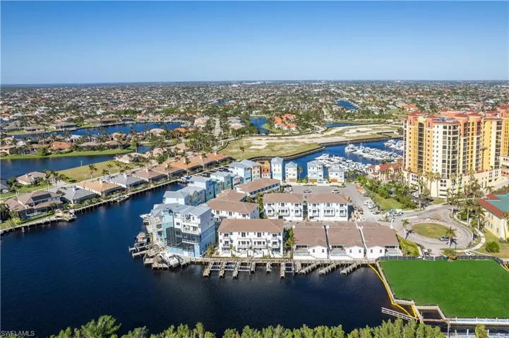 Birds eye view of property with a water view and a residential view