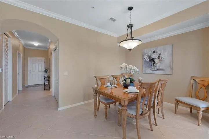 Crown molding and light colored tiles add to the architectural detail
