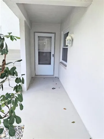 Property entrance with stucco siding