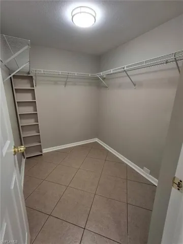 Spacious closet with light tile patterned floors