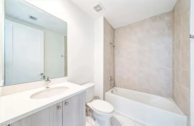 Bathroom featuring vanity and shower / washtub combination