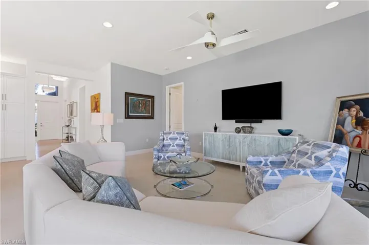 Open area great room with custom paint, ceiling fan.