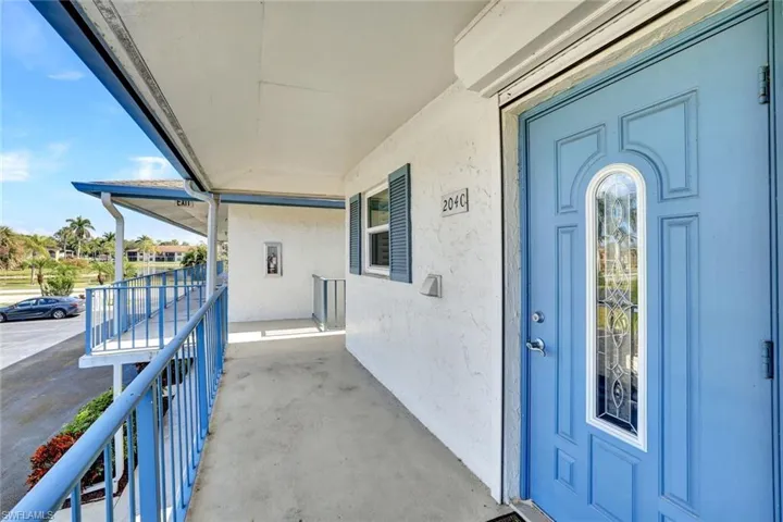 Property entrance with stucco siding and a porch
