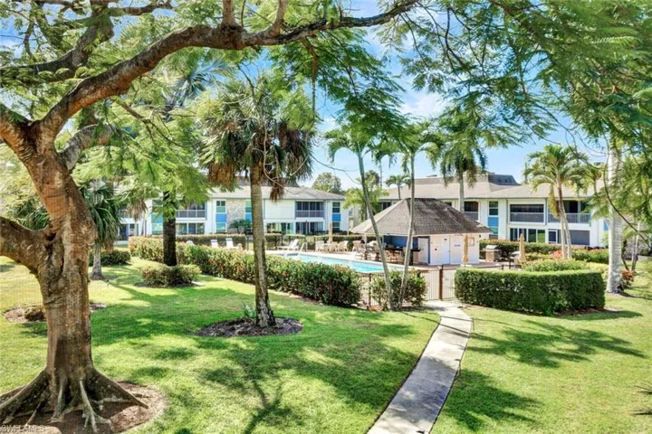 View of property's community featuring a yard and a pool