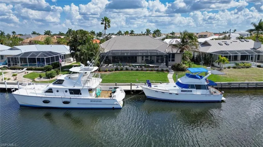 Dock area featuring a yard, a sunroom, and a water view