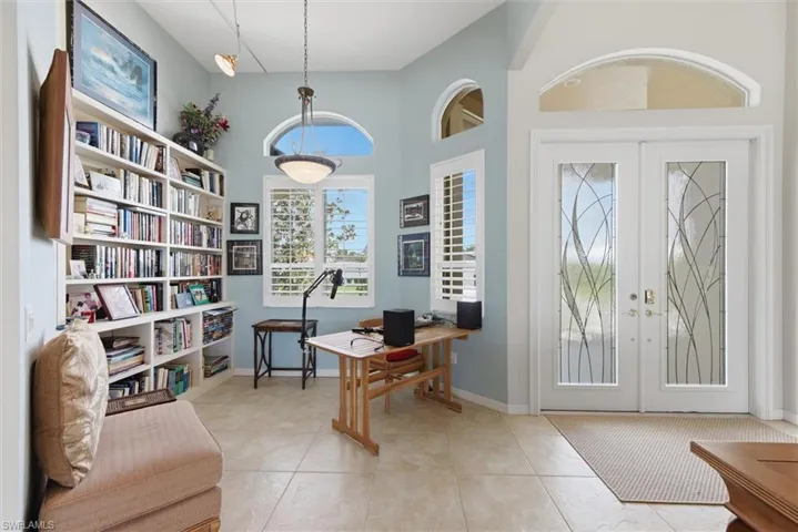 Office area with french doors and light tile patterned floors
