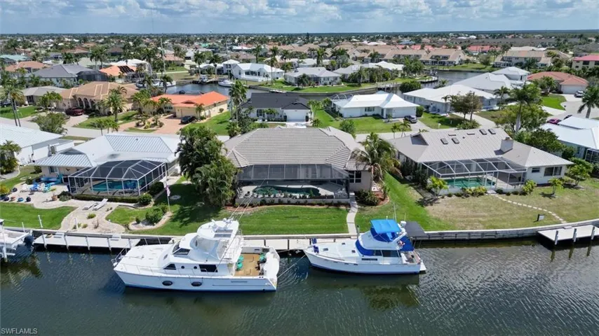 Aerial perspective of suburban area with a nearby body of water