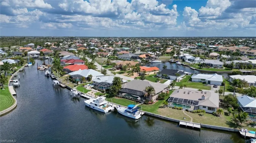 Aerial overview of property's location with nearby suburban area and a large body of water