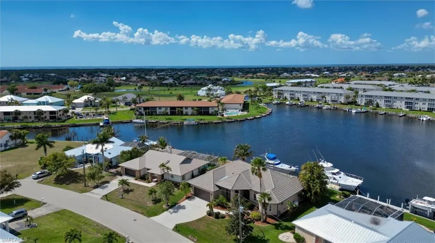 Aerial perspective of suburban area featuring a large body of water
