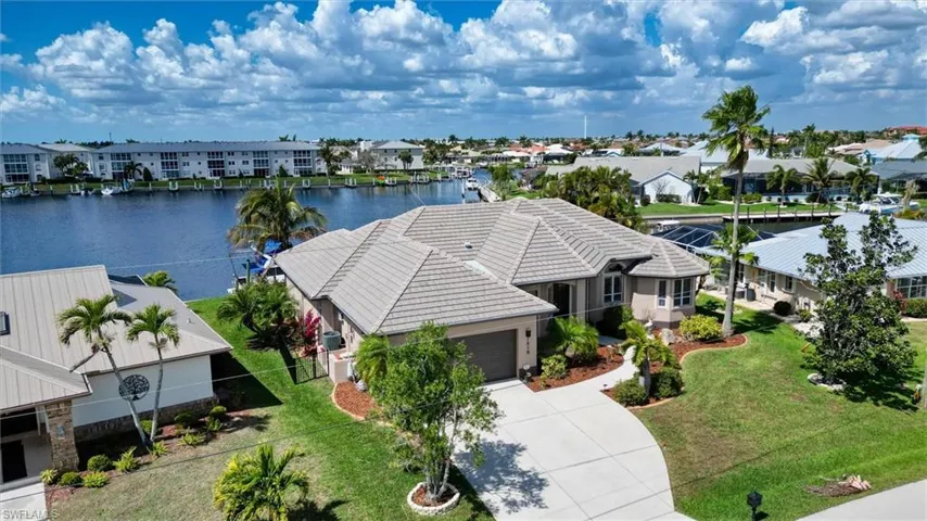 Aerial view of residential area featuring a nearby body of water