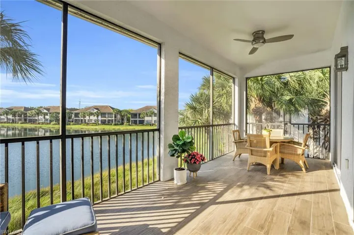 Sunroom / solarium with a water view and ceiling fan