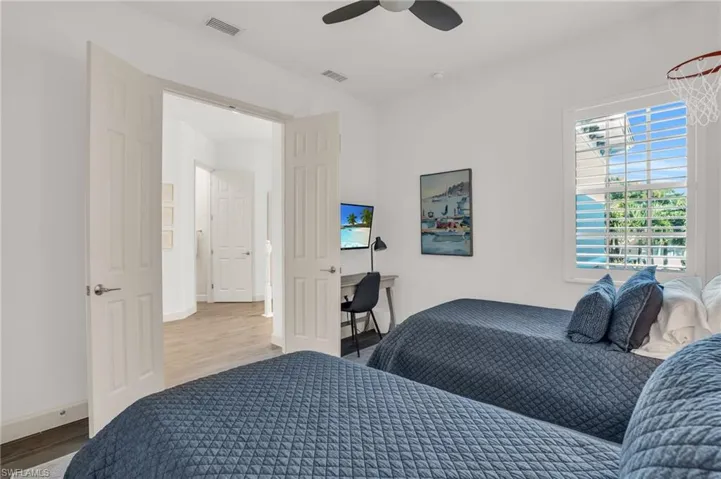 Bedroom with ceiling fan and light hardwood / wood-style flooring