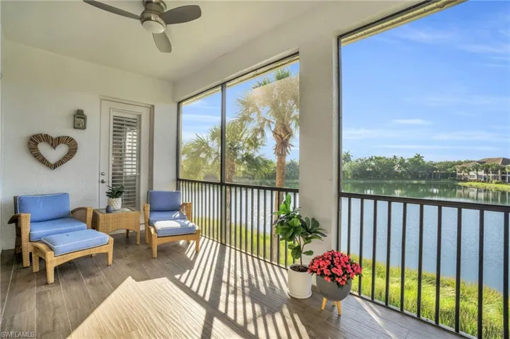 Sunroom with a water view and ceiling fan