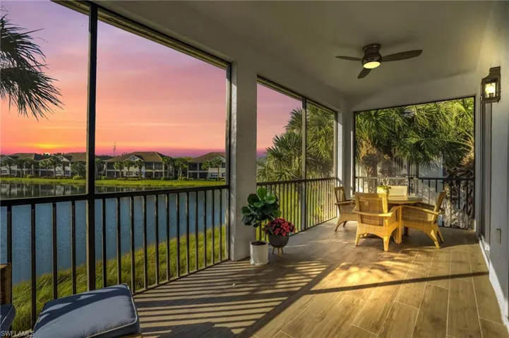 Sunroom / solarium featuring a water view and ceiling fan