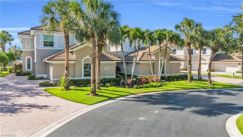 View of front of house with a garage and a front lawn