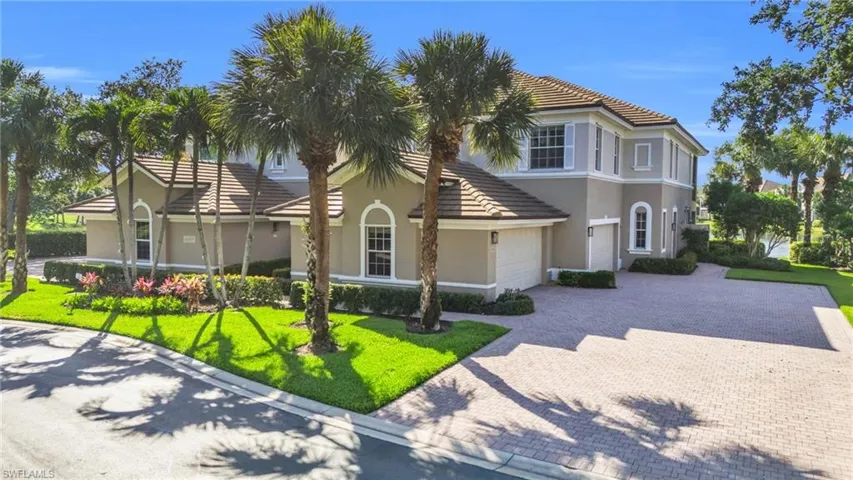 Mediterranean / spanish-style home featuring a garage and a front yard