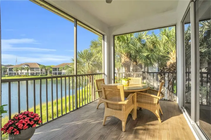Sunroom / solarium featuring a water view