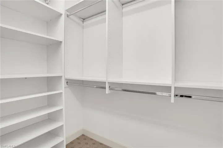 Walk in closet with tile patterned flooring
