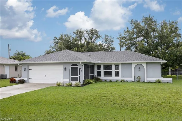 Ranch-style house with stucco siding, concrete driveway, a shingled roof, and a garage