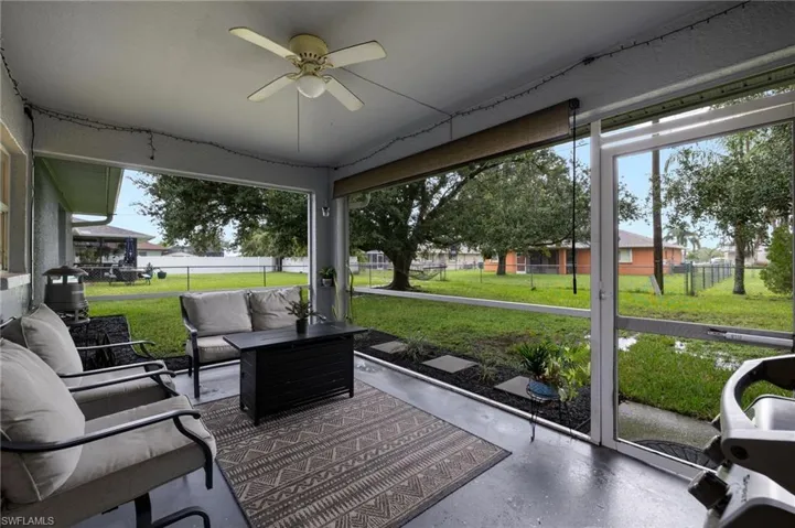Sunroom / solarium featuring ceiling fan, an outdoor living space, and plenty of natural light