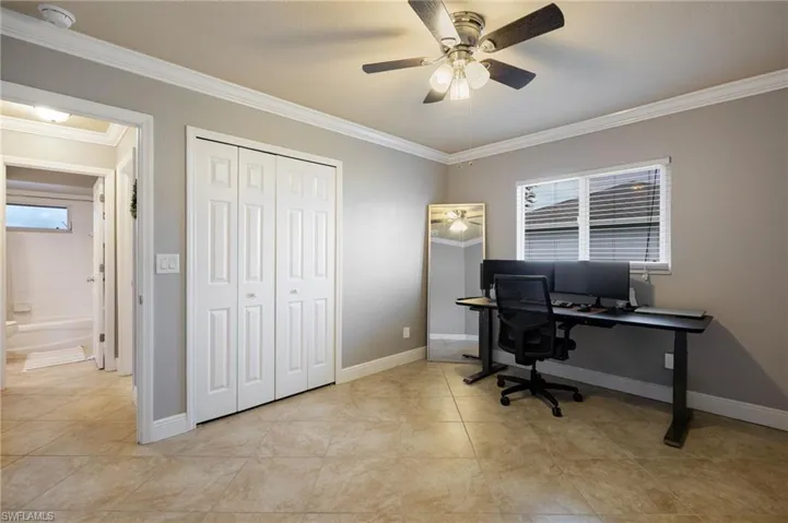 Office featuring ornamental molding, light tile patterned floors, and ceiling fan