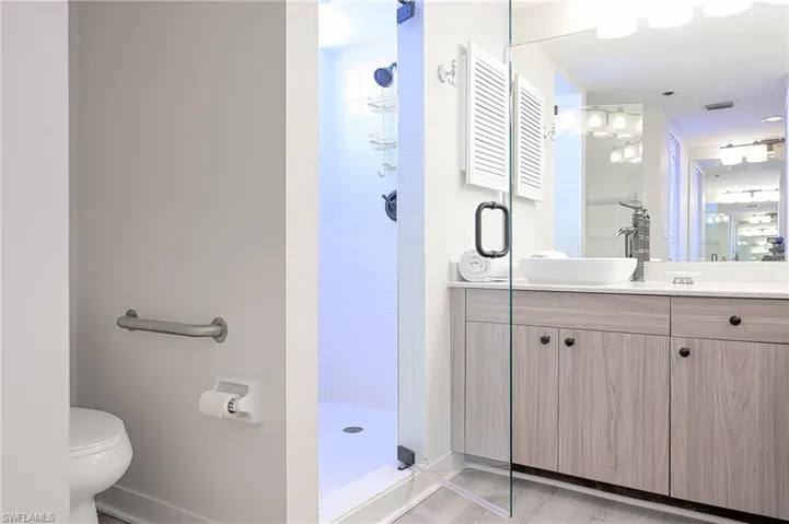 Master Bathroom with a tile shower, vanity, and toilet
