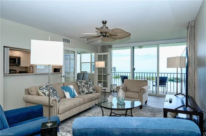 Living room featuring ceiling fan,  hardwood / wood-style flooring, and a breathtaking view of the Gulf