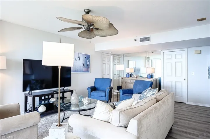 Living room with wood-type flooring and ceiling fan