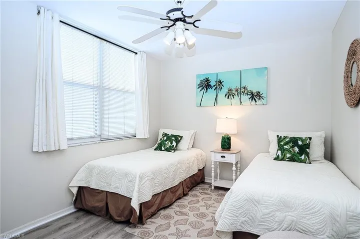 Bedroom featuring ceiling fan and light hardwood / wood-style flooring