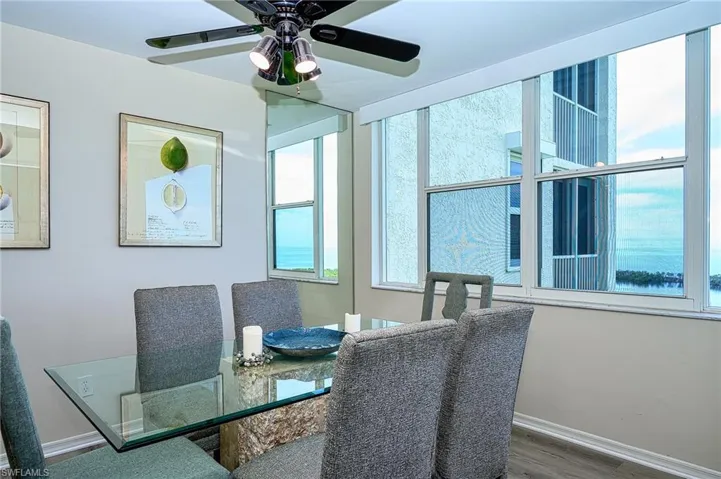 Dining space with ceiling fan, hardwood / wood-style flooring, and Gulf view.  This room could also be a den or office.