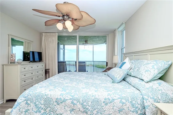 Master Bedroom with beautiful Gulf view and  sliders to the screened lanai so you can sleep with the Gulf breezes flowing in.