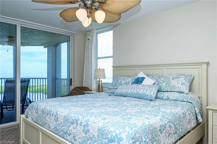 Bedroom with ceiling fan and multiple windows