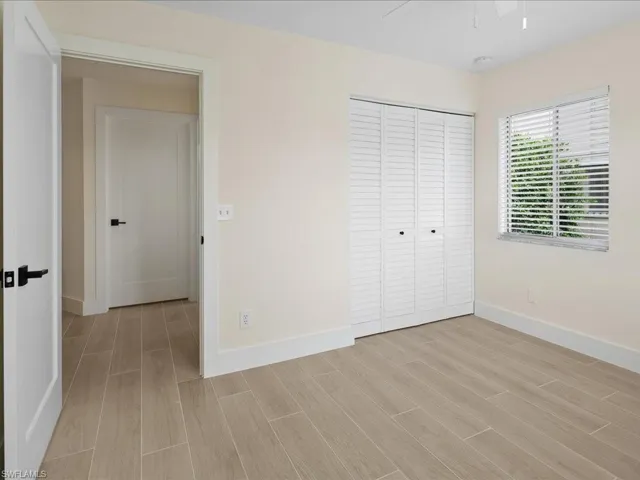 Unfurnished bedroom with light hardwood / wood-style floors, a closet, and ceiling fan