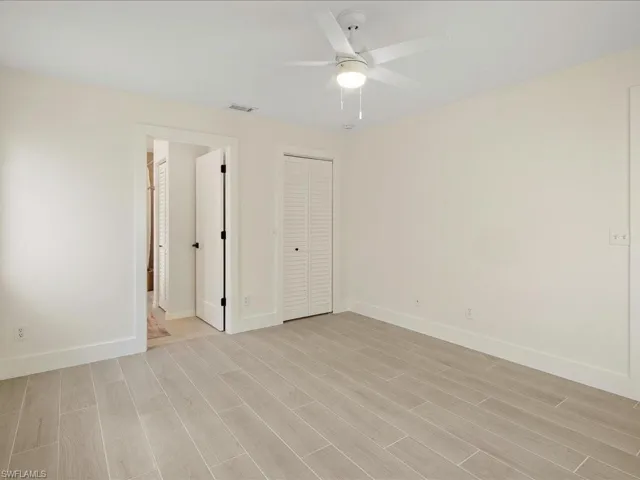 Unfurnished bedroom with light hardwood / wood-style floors, a closet, and ceiling fan