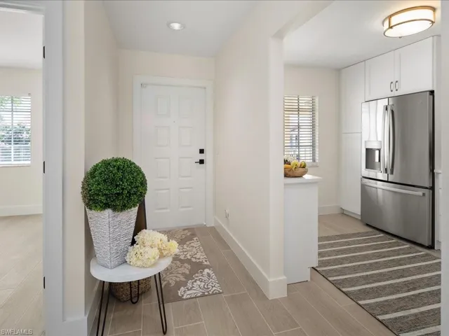 Entrance foyer with light wood-type flooring