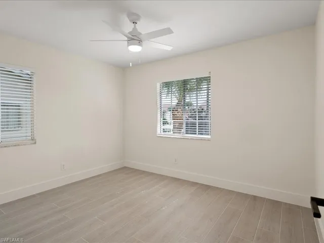 Empty room with light wood-type flooring and ceiling fan