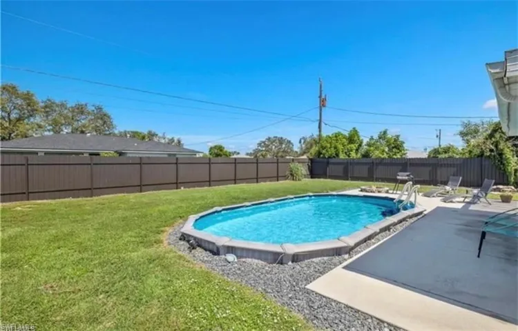 View of swimming pool with a patio and a fenced backyard