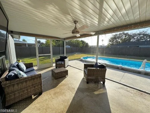 View of swimming pool with an outdoor hangout area, a patio area, and a fenced backyard
