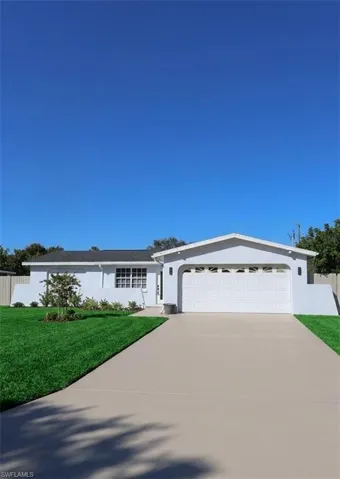 Ranch-style home with driveway, stucco siding, and a garage