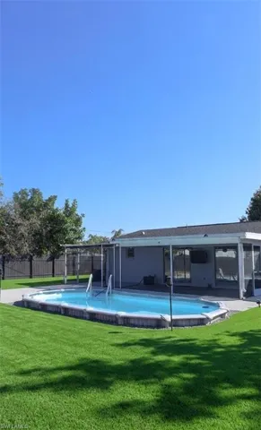 View of pool with patio surround and a sunroom