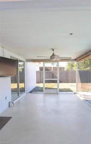 Unfurnished sunroom featuring ceiling fan and plenty of natural light